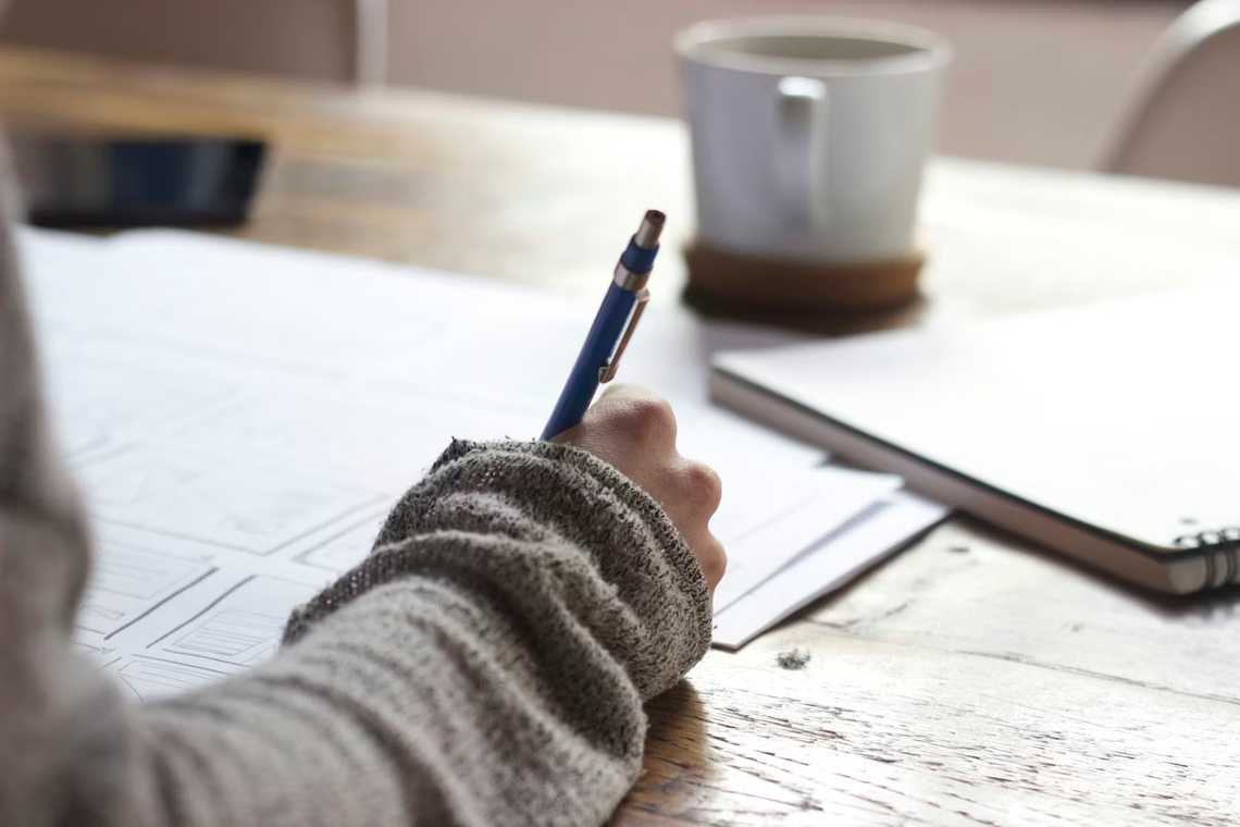 Person taking notes and making financial decisions
